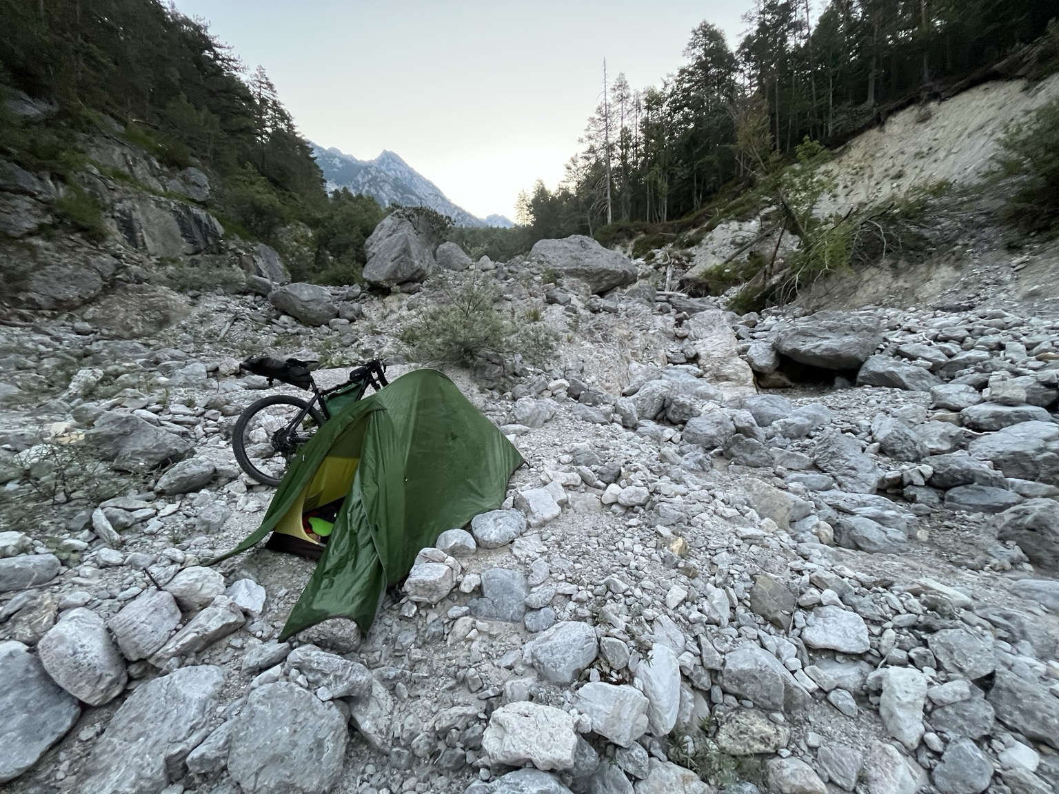 Wildcamping spot with my tent in a very rocky riverbed